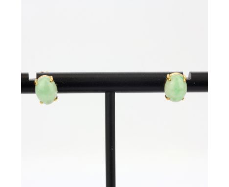 A pair of yellow metal (tested minimum 9ct gold) jade set stud earrings, L. 8cm. With 9ct gold backs.