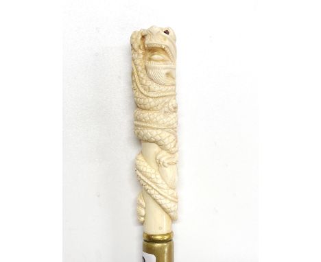 An ornately carved bone handled walking stick, cane L. 99cm, handle L. 15cm.