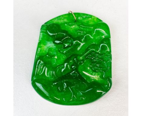 A Chinese carved apple green jade amulet of a mountain landscape with rose gold top ring, H. 5.5cm.