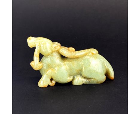 A Chinese celadon and russet jade model of a mythical horse and dragon, L. 8.5cm. H. 4.5cm.