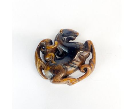 A Chinese russet jade amulet of a woman riding a horse, W. 4.5cm.