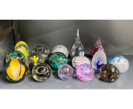 A group of Caithness and other paperweights.
