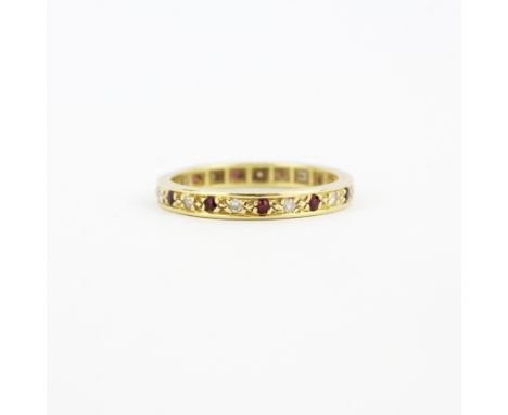 A 9ct yellow gold (worn hallmark) ruby and diamond full eternity ring, (L.5).