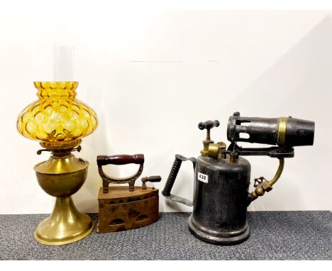 A large brass and iron blow torch, H. 34cm. together with a Victorian cast iron charcoal iron and a brass oil lamp.