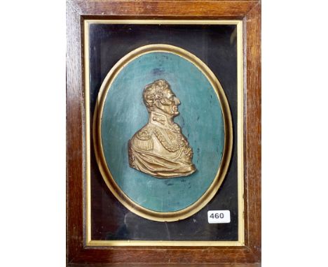 A 19th Century gilt cast metal portrait bust of The Duke of Wellington in a glazed oak cabinet, 35 x 46cm.