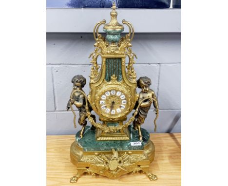 A French gilt brass and green marble mantel clock with enamelled numerals, H. 61cm.