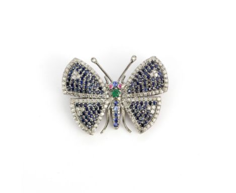 A white and yellow metal (back tested gold) butterfly brooch set with diamonds, sapphires, ruby eyes and an emerald, L. 3.5cm