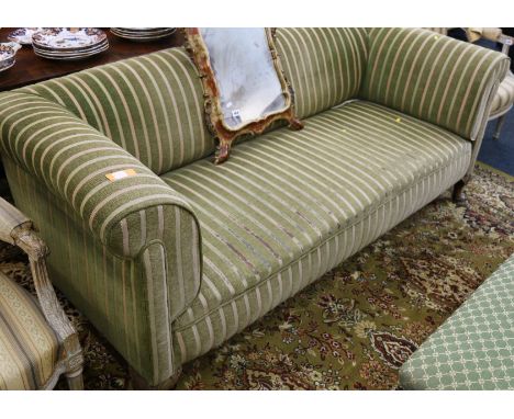 Chesterfield type sofa upholstered in green striped fabric raised on squat cabriole supports.