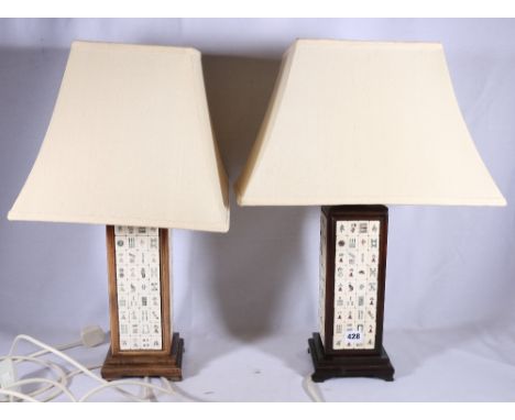 Pair of early 20th Century lamp bases of square section each face set with mah-jongg tiles, filled for electricity, the bases