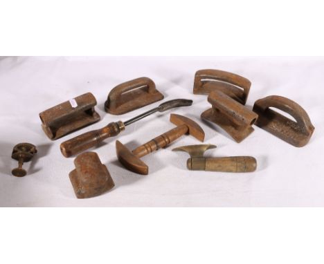 A group of 19th century clothiers tools including a wooden hat stretcher, Kenrick and other wood and brass or steel irons and