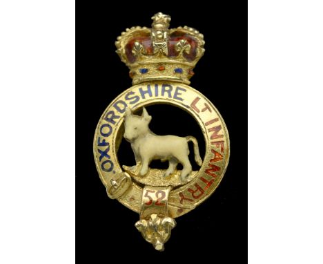 A 52nd (Oxfordshire Light Infantry) Victorian Regimental Brooch, 19mm x 10mm, gilt and enamel, crowned title strap with an ox