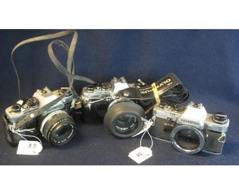 Three Olympus 35mm SLR OM10 camera bodies with two Olympus 50mm lenses , two with everready cases. (3)(B.P. 21% + VAT) Sold a
