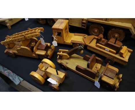 Four hand made hardwood toys, crane, articulated truck with digger, fire engine and tractor, made by John C Davies of Hakin, 