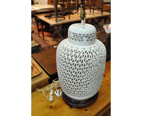 Oriental design cream pierced baluster table lamp on wooden base.(B.P. 21% + VAT) 