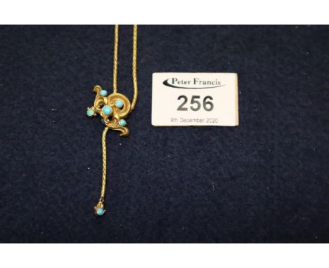 A Victorian bloomed yellow metal pendant on chain set with turquoise with hair locket section to reverse. Approximate weight 