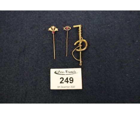 Victorian fan shaped stick pin set with ruby and pearls, a ruby set stick pin and a horseshoe stock pin (3).(B.P. 21% + VAT) 