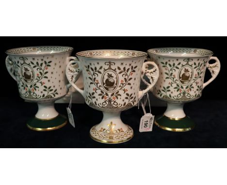 A pair of the Caverswall china Christmas two handled goblets dated 1980 and 1981, limited editions. Together with another Cav