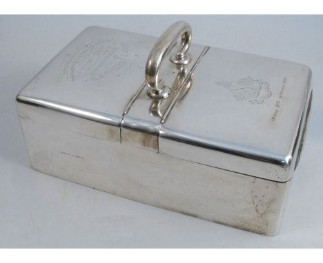 A silver cigarette box, of rectangular form, with central handle and two hinged flaps, with presentation inscription for Worc