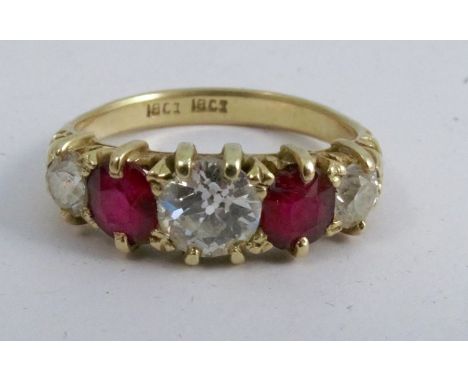 A diamond and ruby five stone ring, stamped '18ct', the three graduated old brilliant cuts totalling approximately 0.9 carats