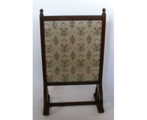 An Edwardian mahogany fire screen, with glazed rectangular panel, having fluted decoration, height 39ins, width 23ins