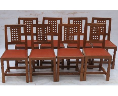 Robert Thompson Mouseman, a set of 8 single dining chairs, with square lattice design to the back, raised on carved front sup