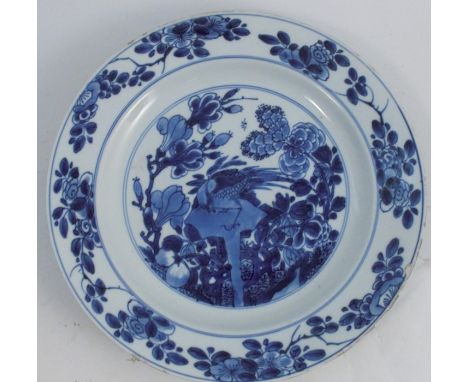 A Chinese Kangxi dish, decorated in blue and white with a bird and foliage, leaf mark to underside, diameter 11ins