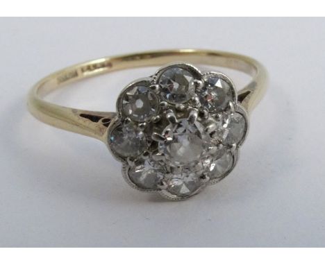 A nine stone diamond cluster ring, stamped '18ct Plat' the old brilliant cuts totalling approximately 0.55 carats, finger siz