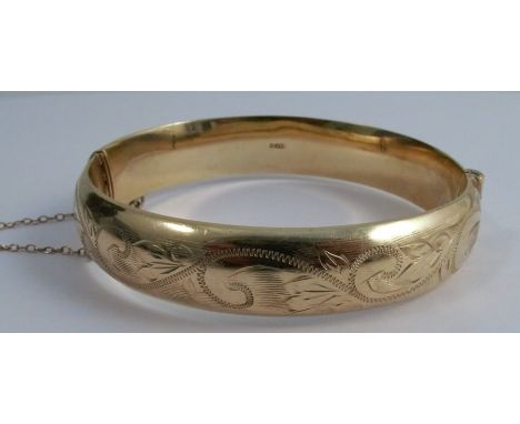 A 9ct gold hinged bangle, with engraved decoration to one half, weight 16.7g