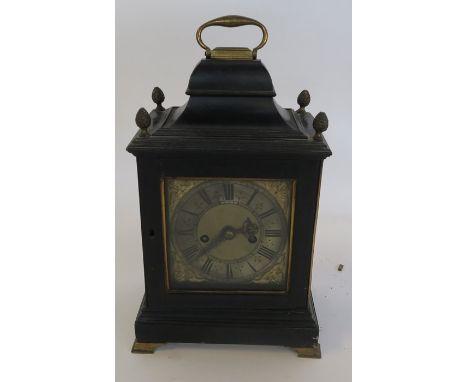 An early 19th century bracket clock, having a square silvered and brass dial, with heavily engraved and chased back plate in 