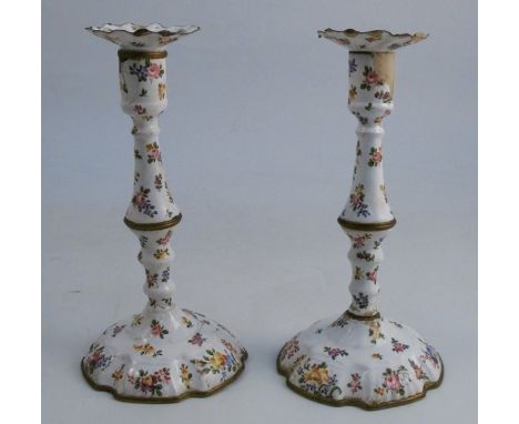 A pair of 19th century Bilston enamel candlesticks, decorated with flowers to a white ground, af, height 10ins
