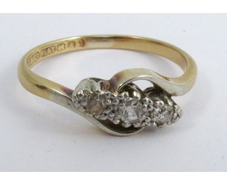 A three stone diamond ring, stamped '18ct Plat', illusion set, finger size N, 2.6g gross