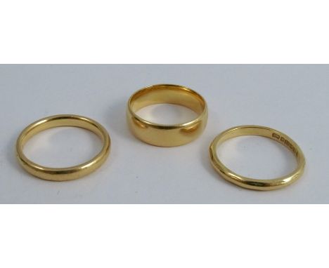 A 22 carat gold wedding ring, together with two others, 12g gross