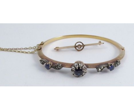 A diamond and sapphire hinged bangle, circa 1900, the detachable cluster centre with bar brooch fitting also, the approximate