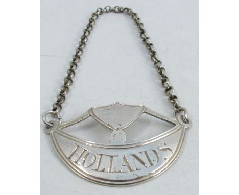 An 18th century silver bottle ticket, with shield shaped cartouche over a curve engraved Hollands, London 1794, maker John Sa