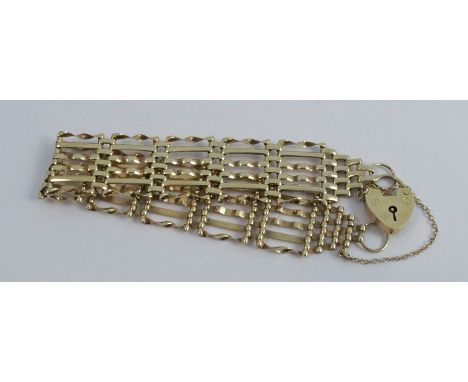 A 9 carat gold bracelet, of six bar gate links design, to a padlock clasp, 13g gross