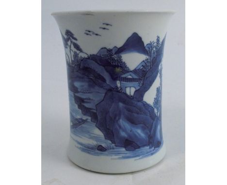 A Kangxi porcelain vase, with flared rim, decorated in blue and white with a figure in a boat on a river with building and la