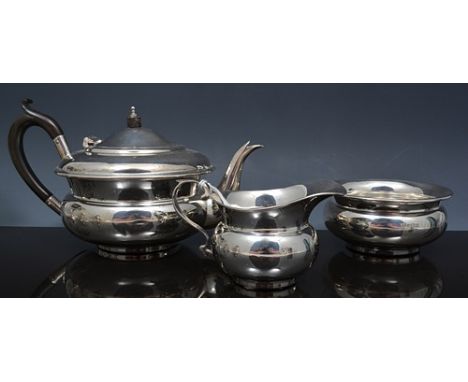 Three piece tea set,  London probably 1919, compressed circular form, comprising a teapot, composition handle and finial 12cm