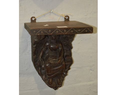 Victorian carved oak and pine wall bracket, designed with a Dutch Lady, 30cm.