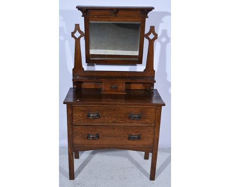 Edwardian oak dressing table, Arts & Crafts style, rectangular bevelled adjustable mirror, above a trinket drawer, two furthe