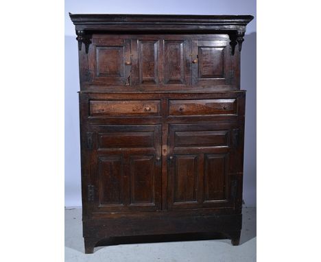 Joined oak court cupboard, basically 18th Century with a moulded cornice, panelled cupboards and drawers, now on bracket feet