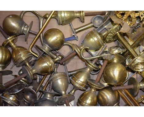 Quantity of brass curtain accessories, including pole rings, finials, tie backs etc, in 3 boxes.