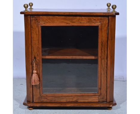 Small Victorian walnut table cabinet, brass finials, glazed door enclosing a shelf, bun feet, with key, width 54cm.