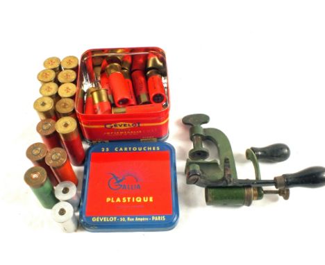 An assortment of 12 bore cartridges including French examples of their original tin with a 12 bore reloading tool in fine ori