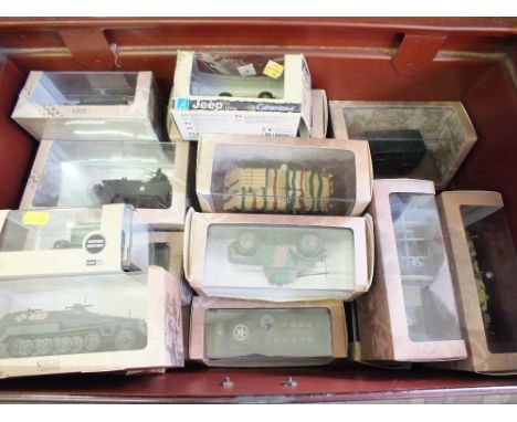 A tin trunk containing boxed Atlas military vehicles