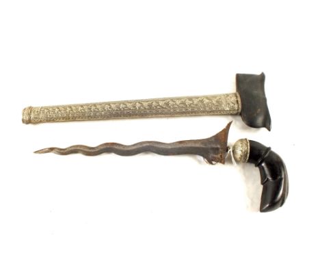 An Indonesian kris with white metal embellished scabbard
