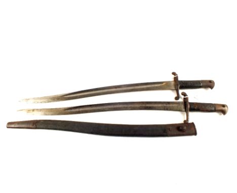 A model 1856 sword bayonet, blade marked "Parker Field & Sons, 233 Holborn, London with scabbard together with another exampl