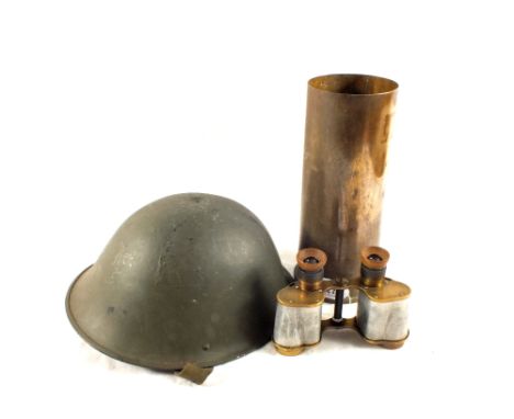 A British Mk V military steel helmet with liner and stamp with a brass shell case and WWII era binoculars