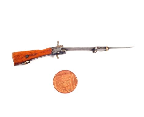 A rare miniature "fully functioning" pinfire rifle, complete with attached bayonet and wooden stock.  Barrel marked "Austria"