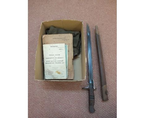 A 1913 model Remington bayonet with scabbard and three manuals including "Standard Technical Training Notes" (March 1944).  A