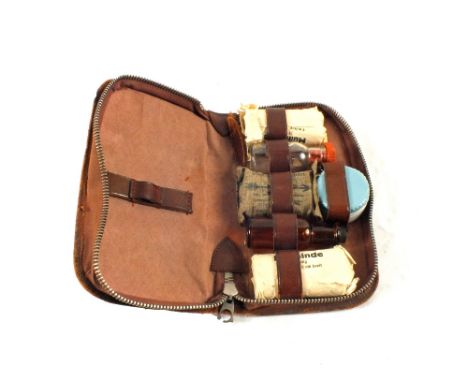 A vintage German personal First Aid kit in a leather case